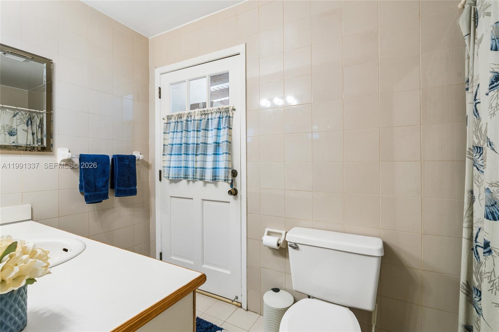 11403 Southwest 129th Place Miami, FL 33186 - Photo 19 of 38 a white toilet sitting next to a bathroom sink