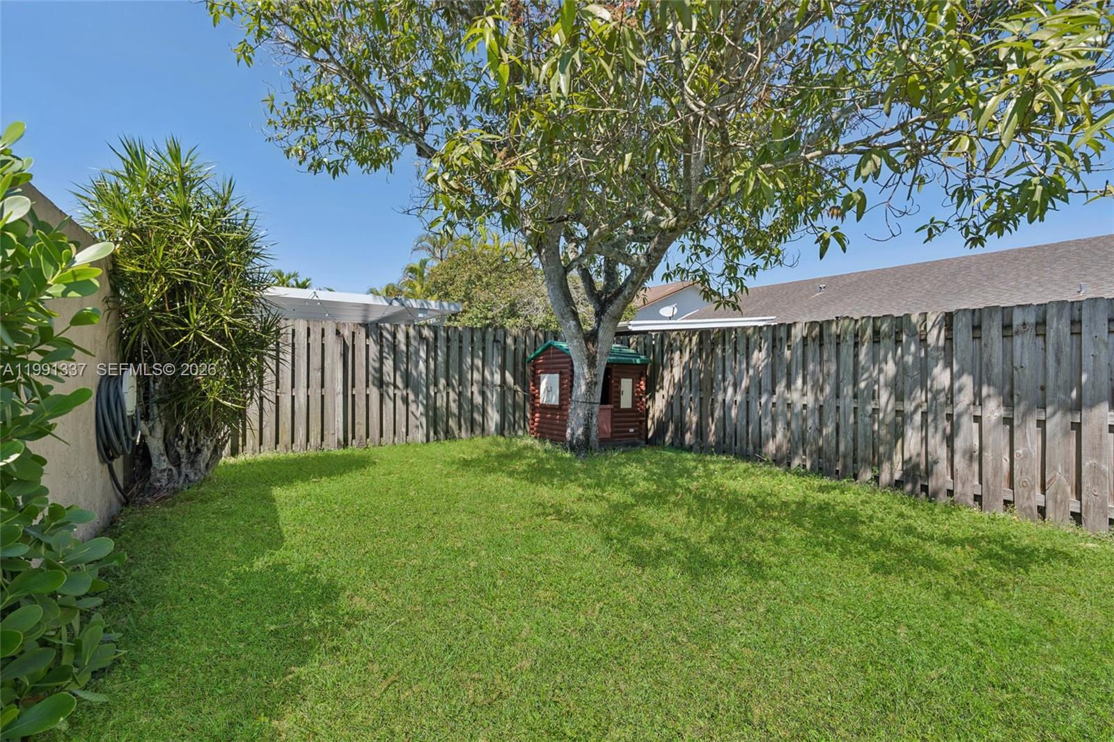 11403 Southwest 129th Place Miami, FL 33186 - Photo 20 of 38 a view of a yard with large trees and wooden fence