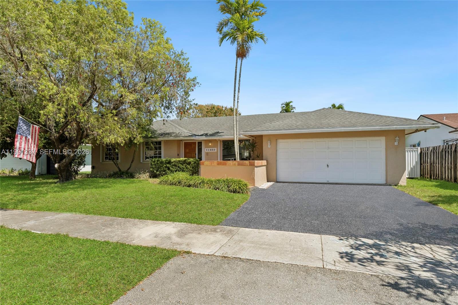 11403 Southwest 129th Place Miami, FL 33186 - Photo 2 of 38 a front view of a house with a yard and garage