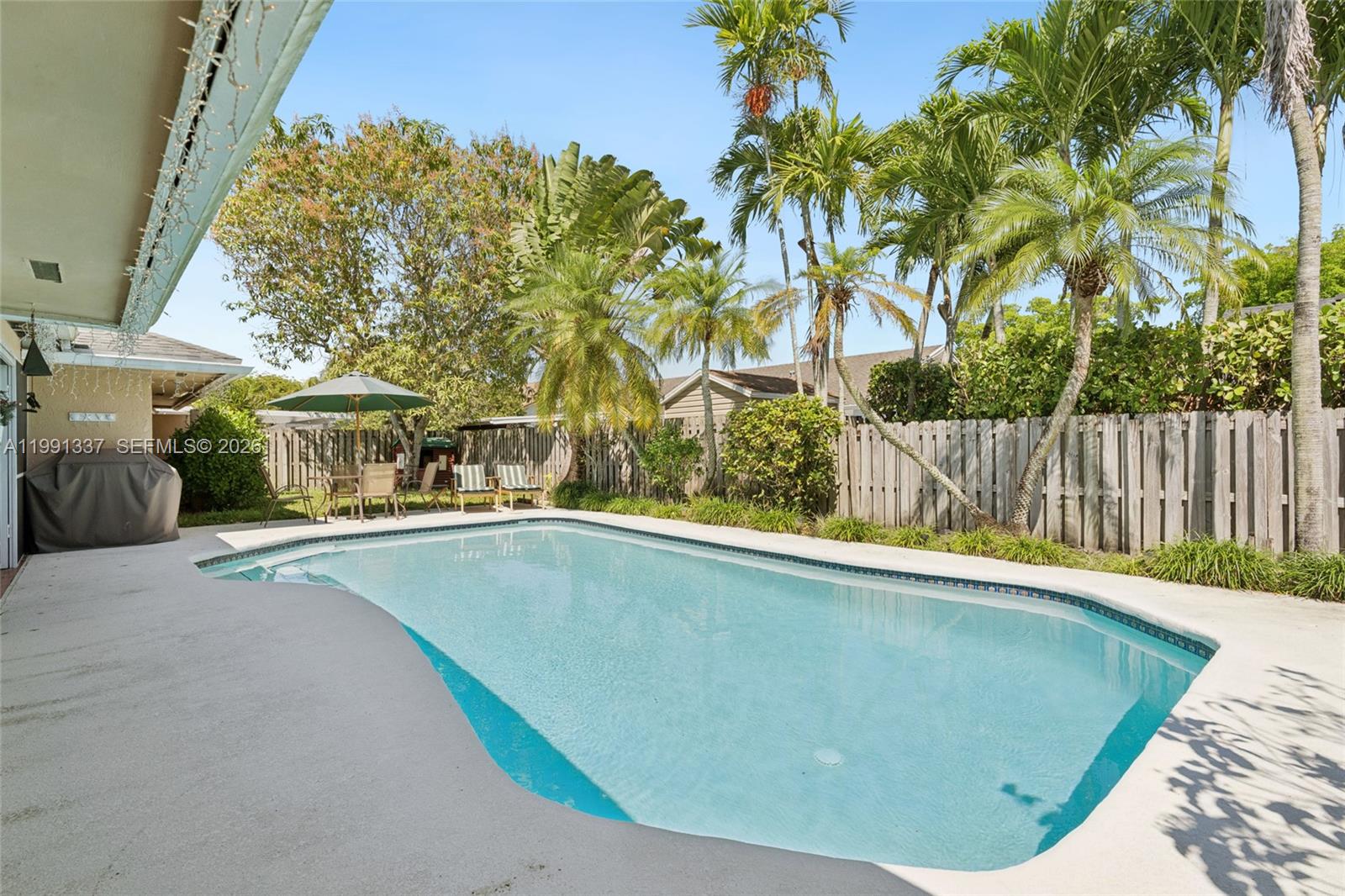 11403 Southwest 129th Place Miami, FL 33186 - Photo 28 of 38 a view of outdoor space and swimming pool