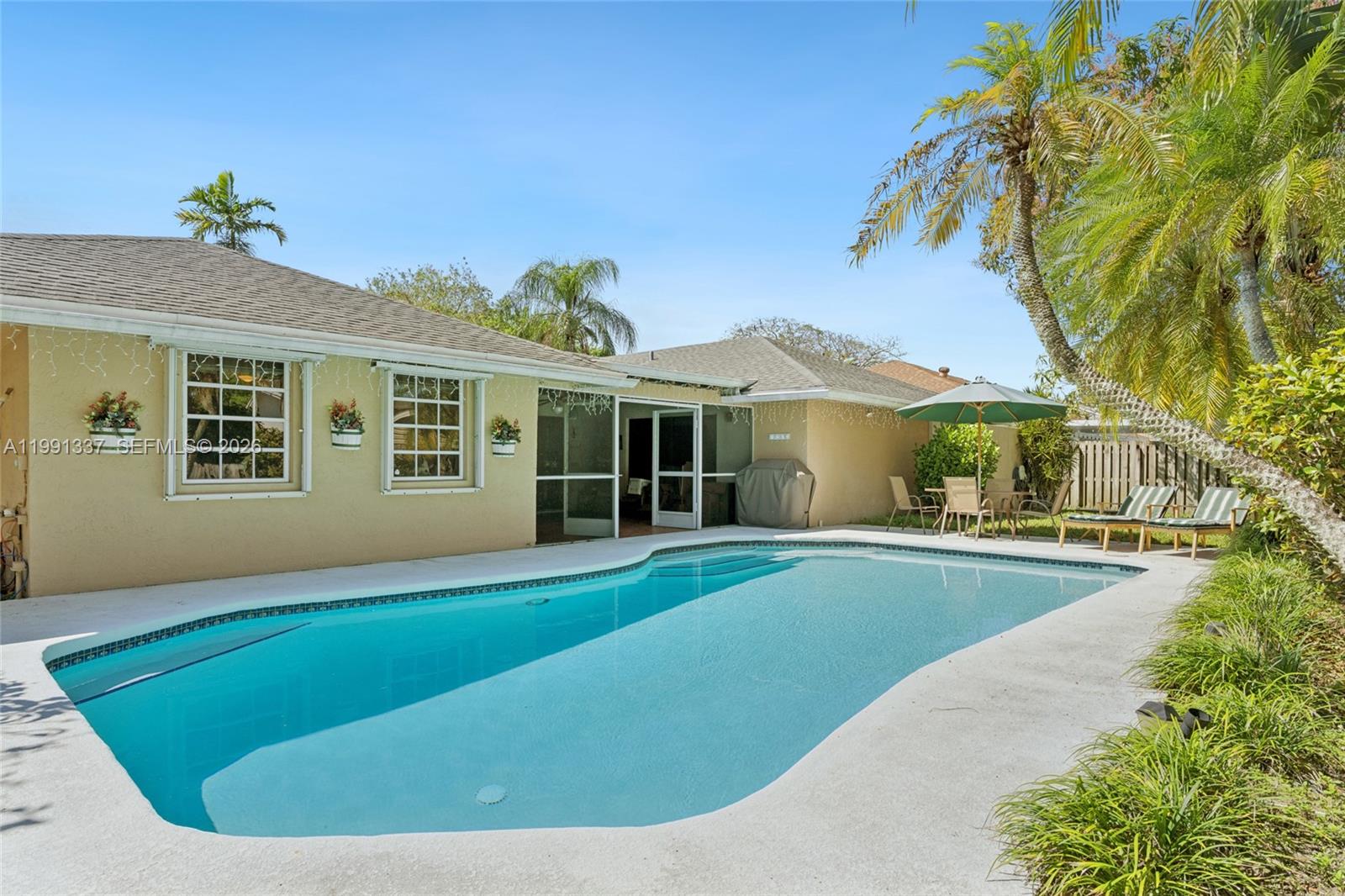 11403 Southwest 129th Place Miami, FL 33186 - Photo 29 of 38 a view of a house with swimming pool and sitting area