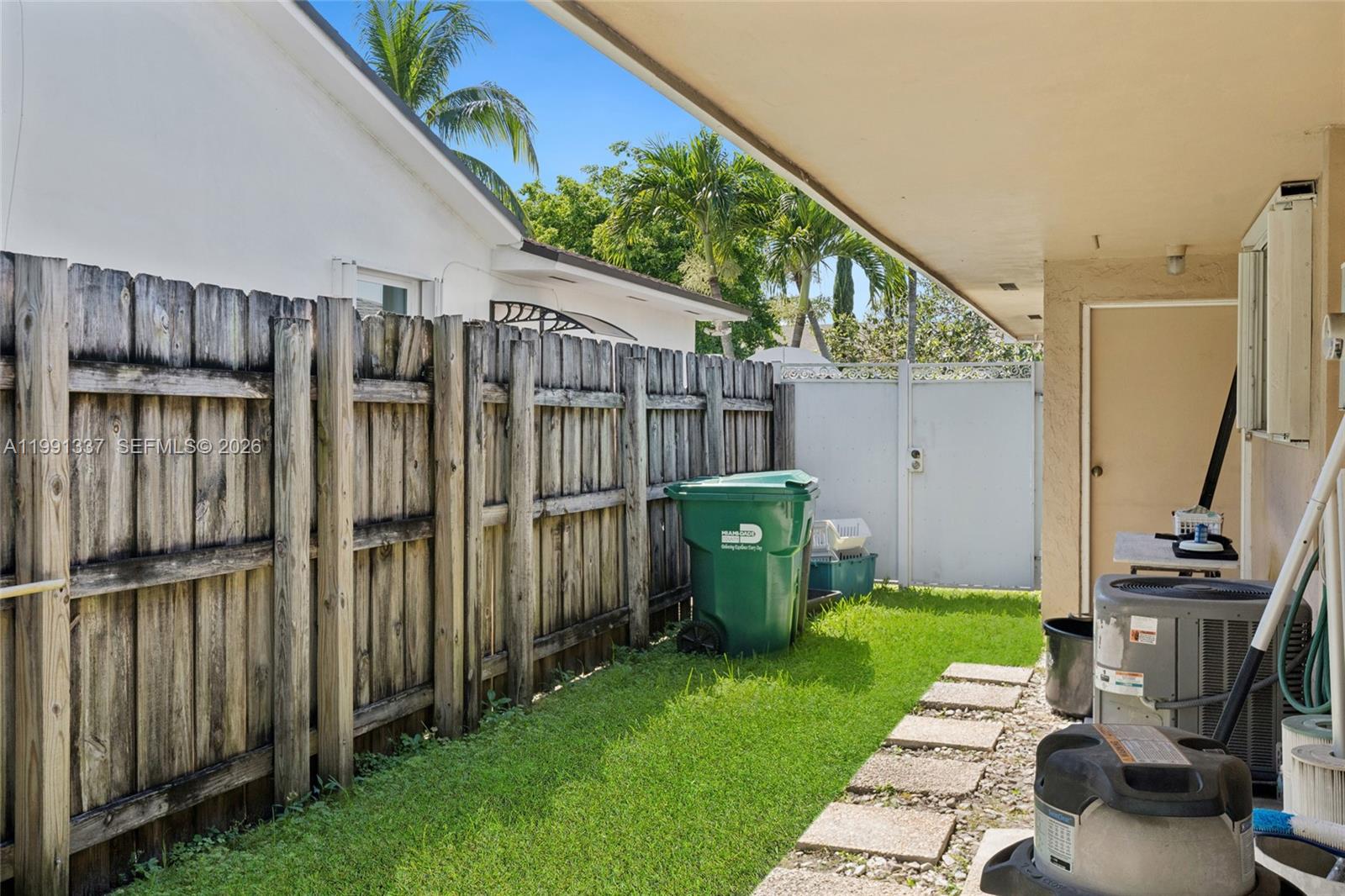 11403 Southwest 129th Place Miami, FL 33186 - Photo 31 of 38 a view of a backyard with chairs and a grill