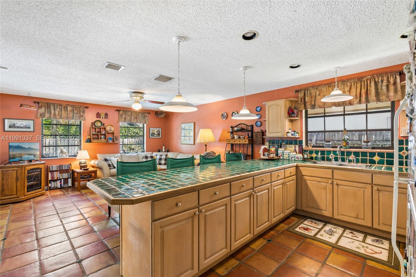 11403 Southwest 129th Place Miami, FL 33186 - Photo 10 of 38 a kitchen with stainless steel appliances granite countertop a sink and cabinets