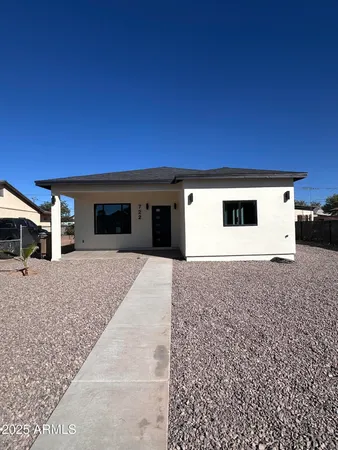 a backyard of a house with garage and parking space