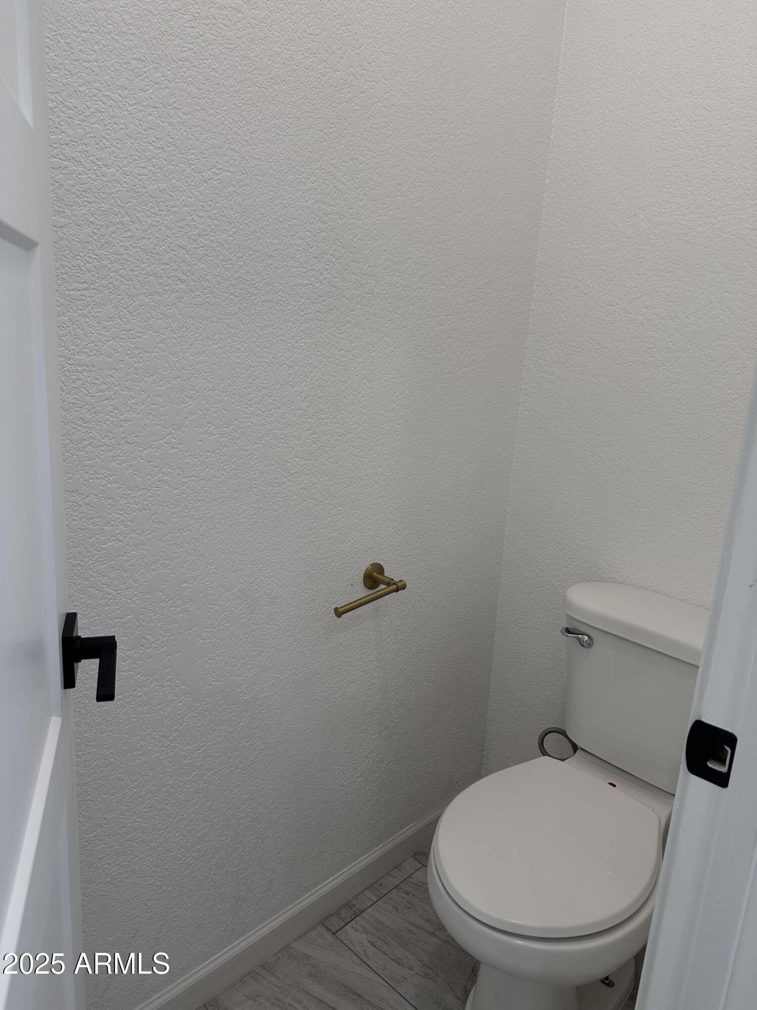 722 East 3rd Street Douglas, AZ 85607 - Photo 18 of 24 a white toilet sitting next to a wooden wall