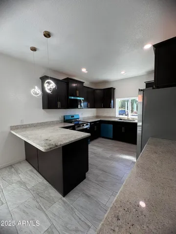 a kitchen with stainless steel appliances granite countertop a stove and a sink