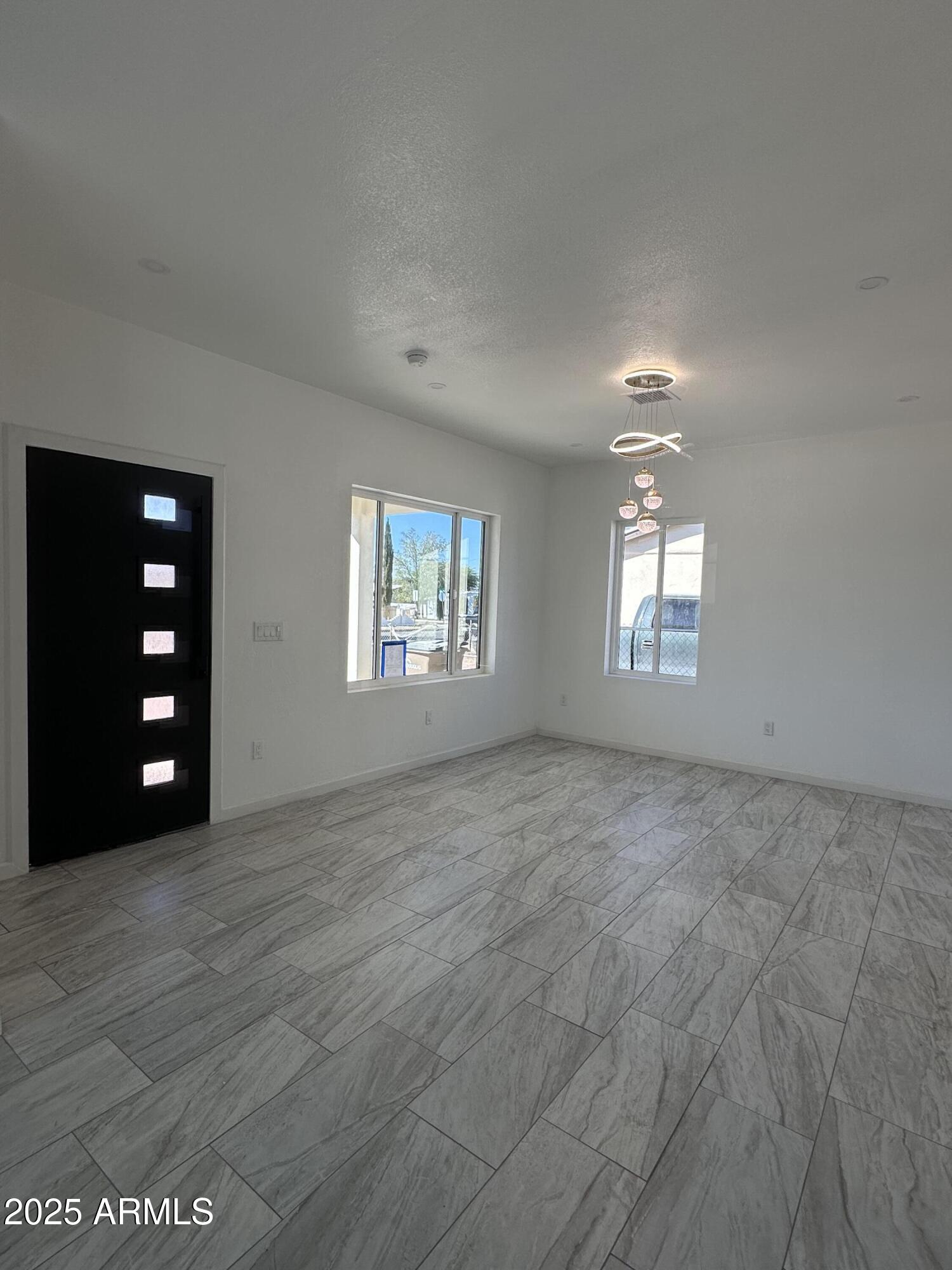 722 East 3rd Street Douglas, AZ 85607 - Photo 4 of 24 a view of an empty room with windows and closet