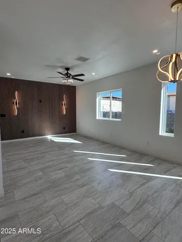 a view of a livingroom with a ceiling fan and window