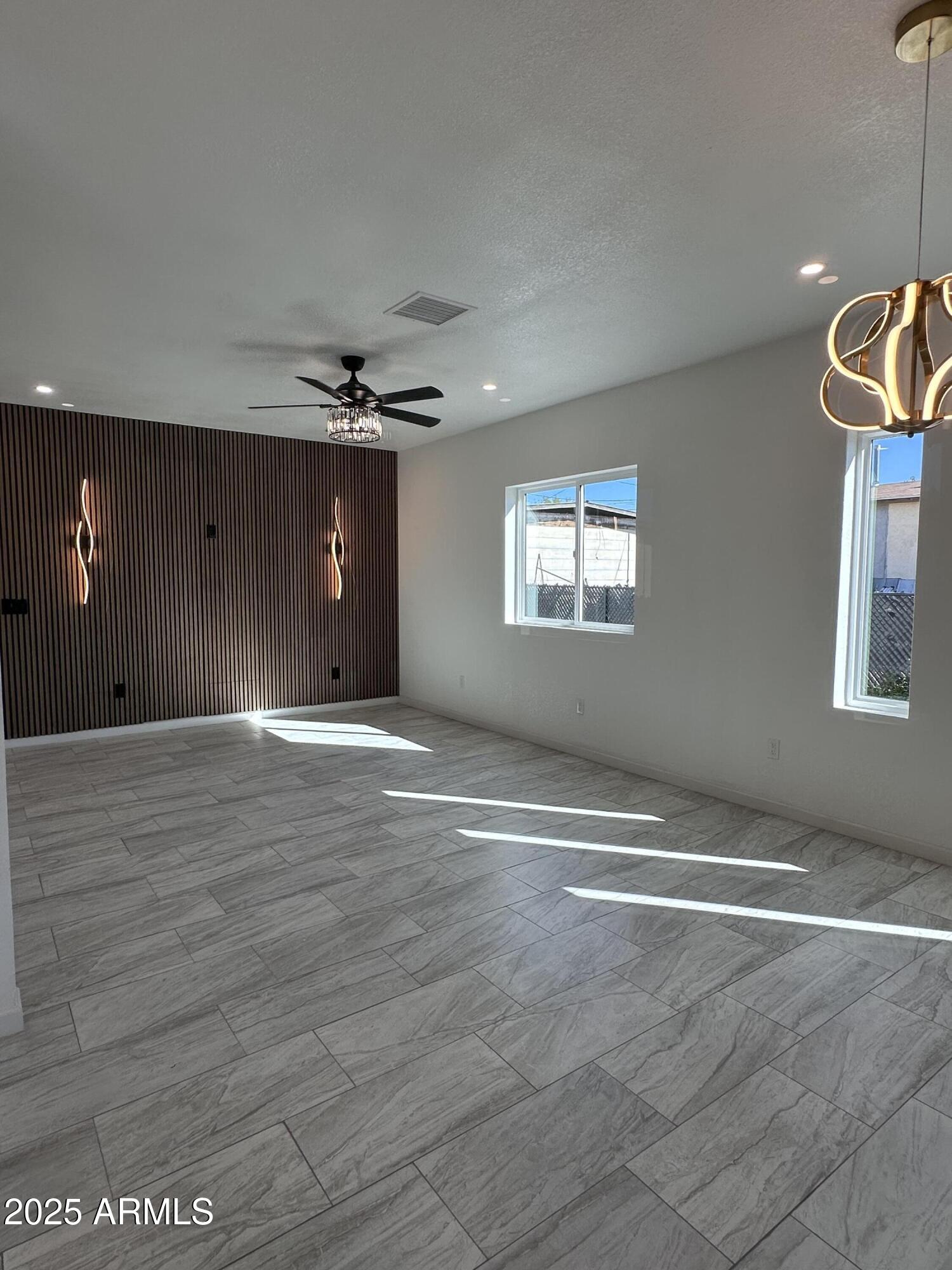 722 East 3rd Street Douglas, AZ 85607 - Photo 6 of 24 a view of a livingroom with a ceiling fan and window