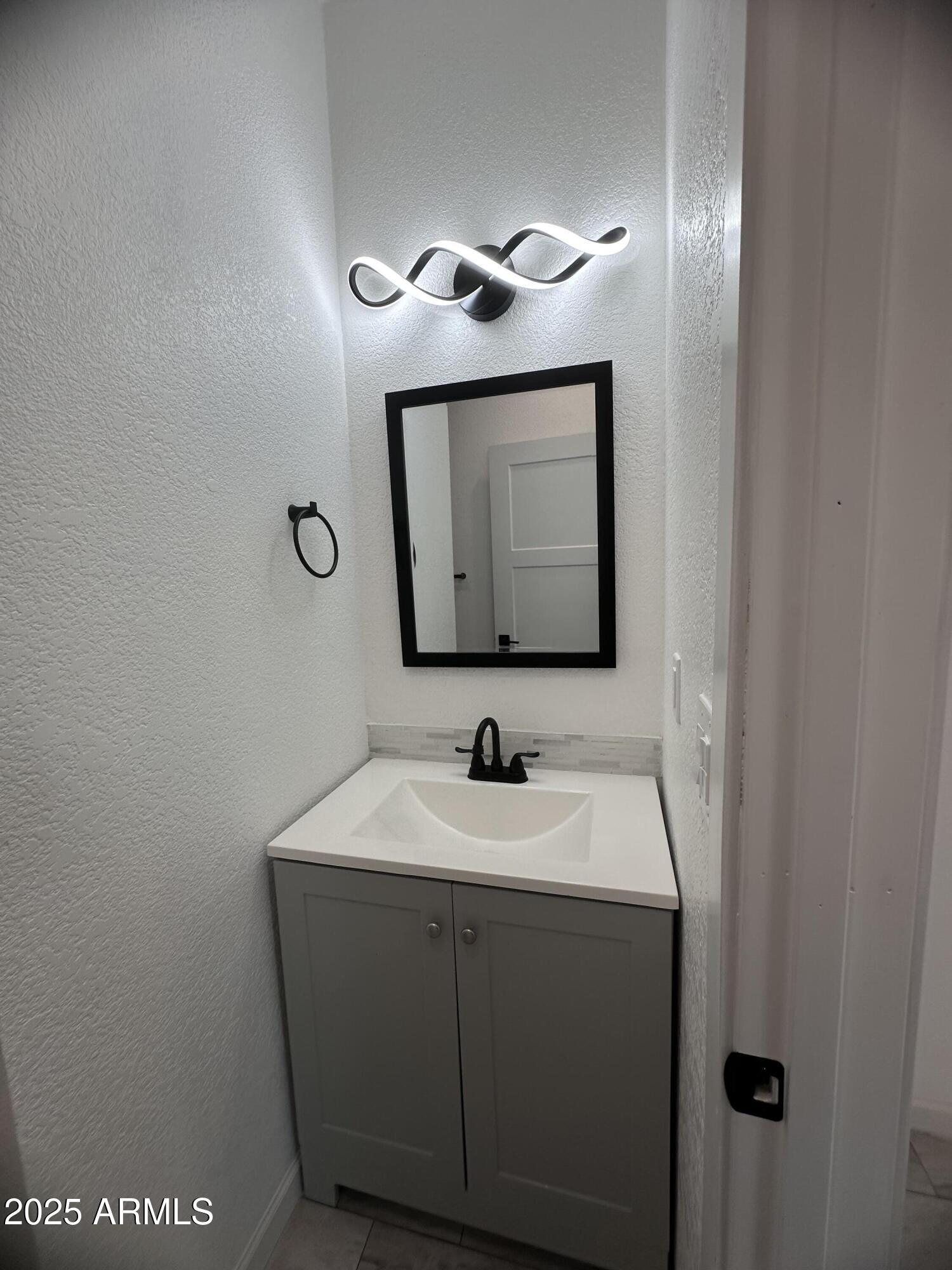 722 East 3rd Street Douglas, AZ 85607 - Photo 9 of 24 a bathroom with a sink and a mirror