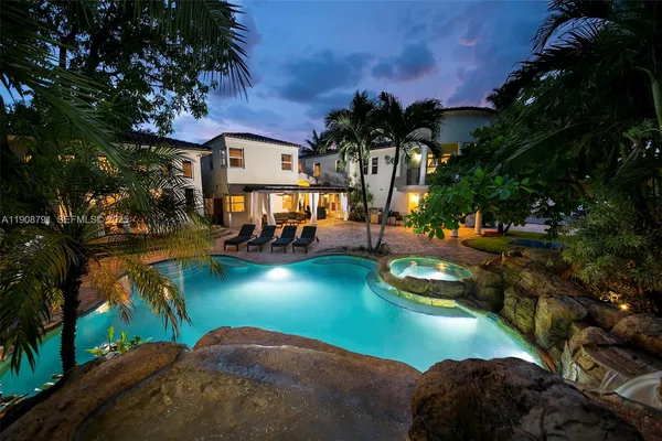 an aerial view of a house with swimming pool yard and outdoor seating