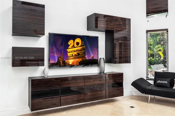 a living room with furniture flat screen tv and appliances