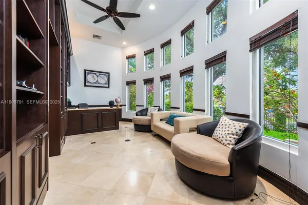 a living room with patio furniture and a large window