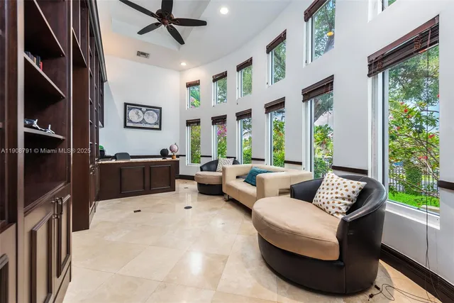 a living room with patio furniture and a large window