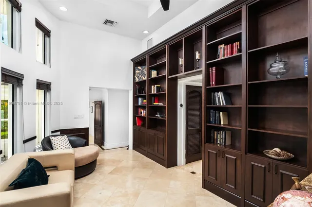 a living room with furniture and a book shelf