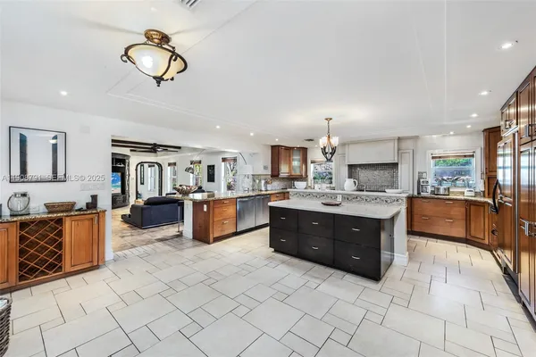 a large kitchen with a large counter top appliances and cabinets