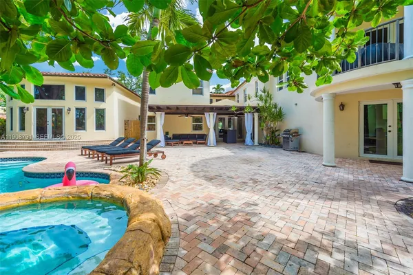 a view of a house with backyard and sitting area