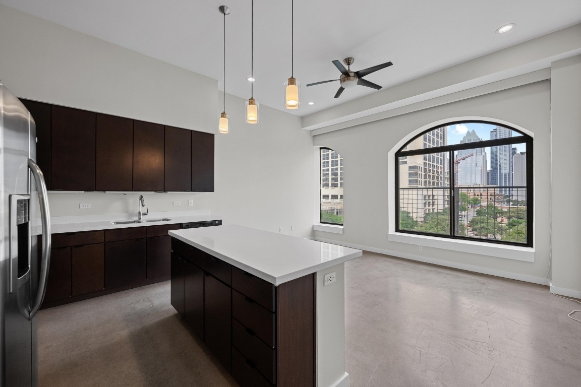 507 Sabine Street, Unit 503 Austin, TX 78701 - Photo 1 of 23 a kitchen with kitchen island a sink stainless steel appliances and cabinets