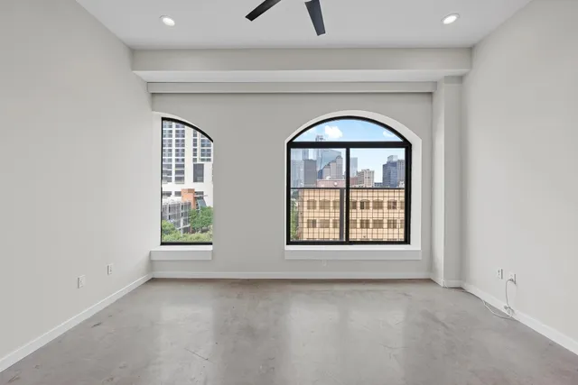an empty room with a window and a fireplace
