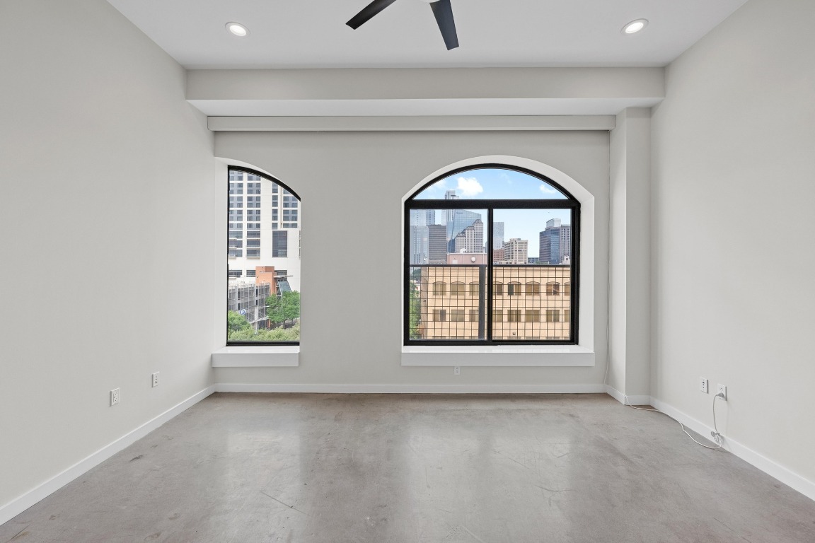 507 Sabine Street, Unit 503 Austin, TX 78701 - Photo 12 of 23 an empty room with a window and a fireplace