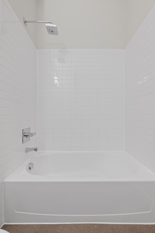 507 Sabine Street, Unit 503 Austin, TX 78701 - Photo 20 of 22 a bathroom with a bathtub and a shower