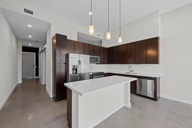 a kitchen with stainless steel appliances a refrigerator and a microwave