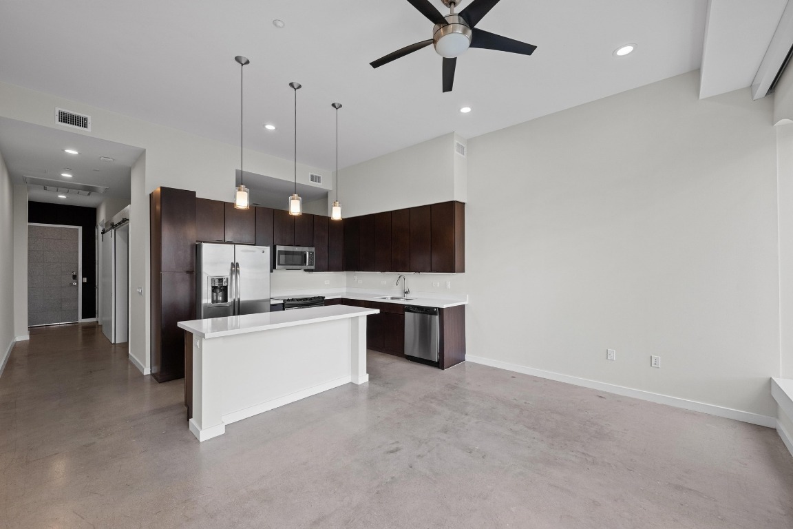 507 Sabine Street, Unit 503 Austin, TX 78701 - Photo 8 of 22 a large kitchen with a large counter top appliances and cabinets