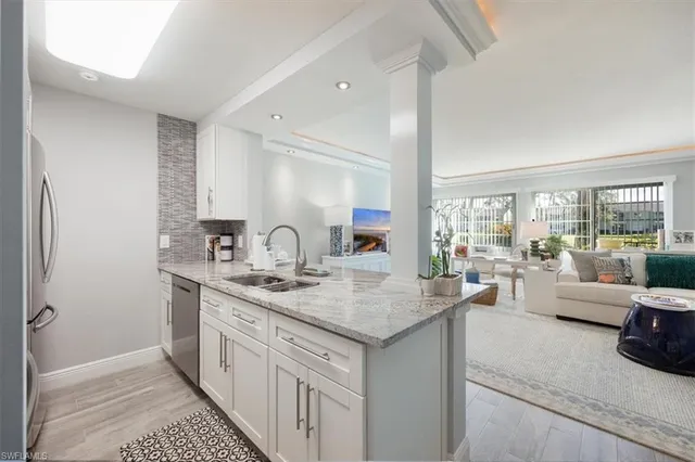 a kitchen with sink and view living room