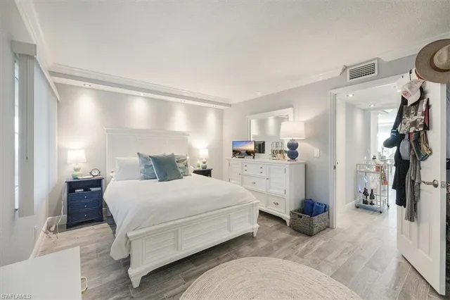 a bedroom with a bed and a view of kitchen