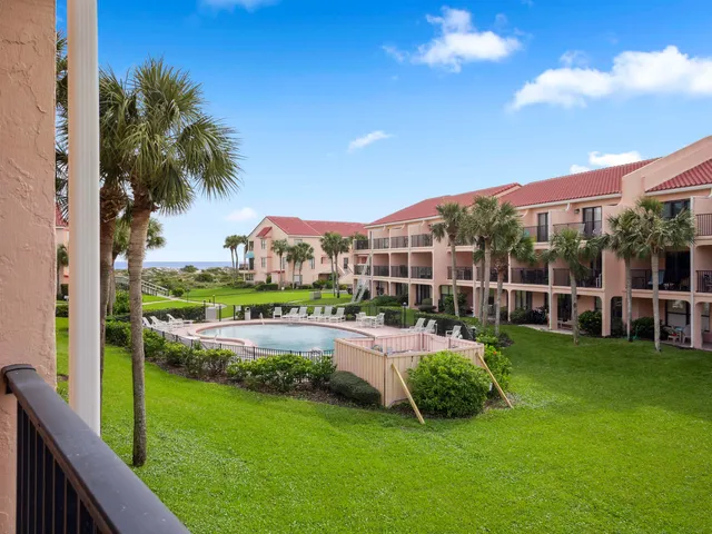 a view of hallway with stairs and wooden floor