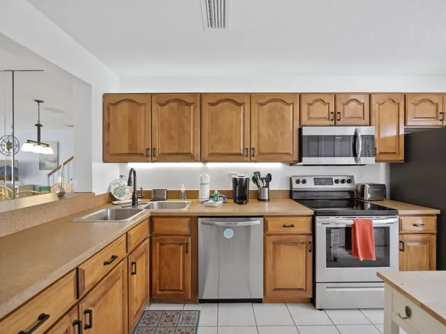 a kitchen with a sink dishwasher and cabinets