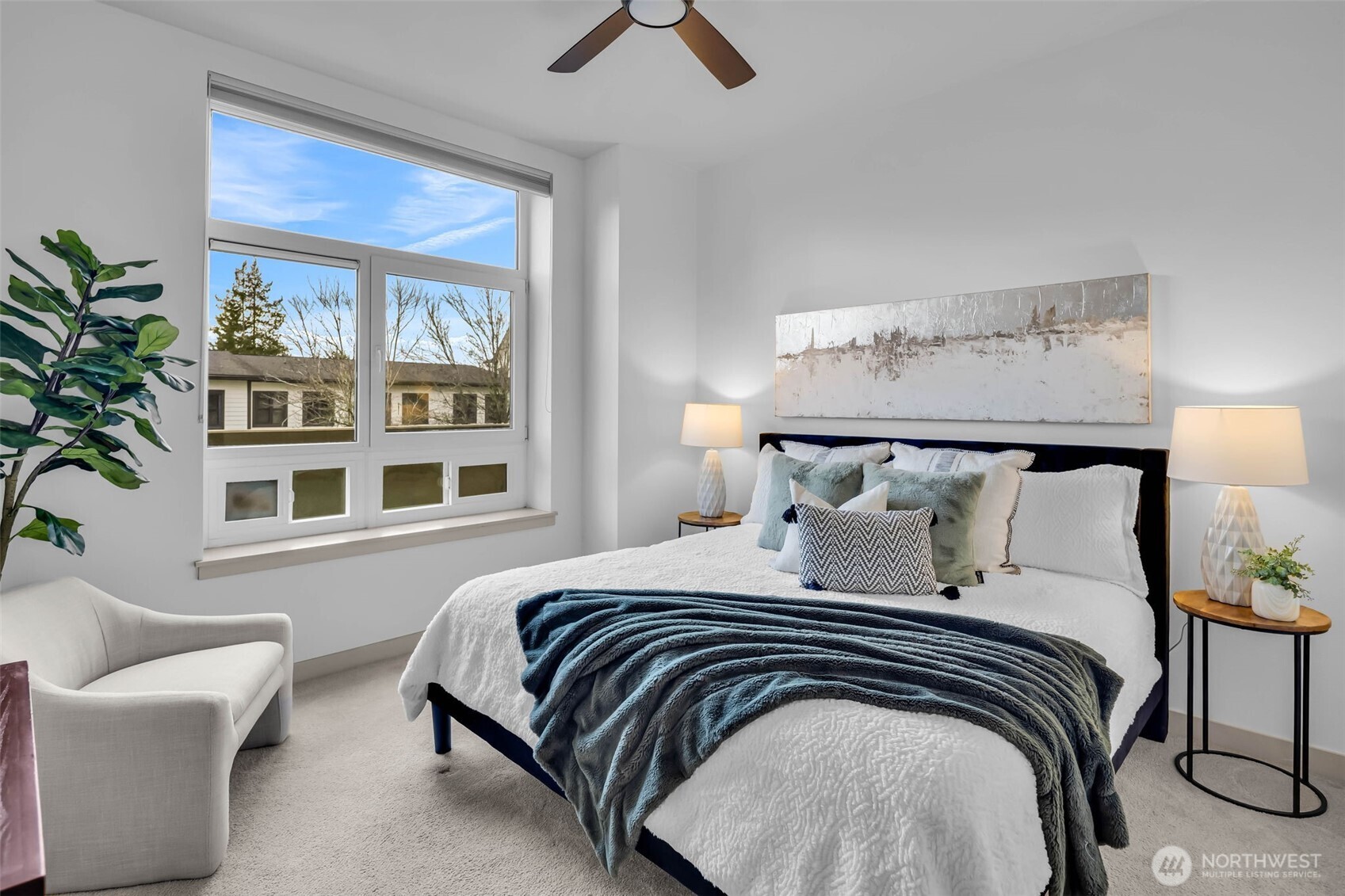 5001 California Avenue Southwest, Unit 103 Seattle, WA 98136 - Photo 19 of 40 a bedroom with a large bed and a chandelier