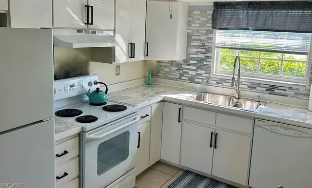 a kitchen with appliances cabinets and a sink