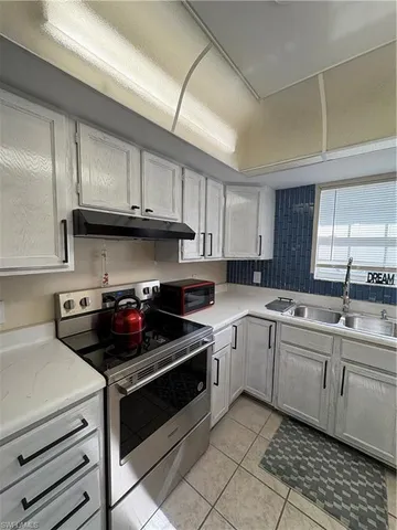 a kitchen with a sink and cabinets