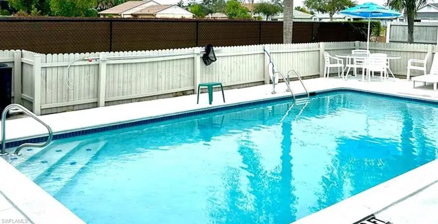 a view of a swimming pool with a patio