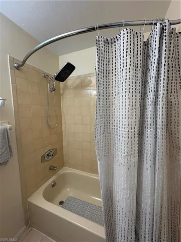 a bathroom with a shower and a bath tub