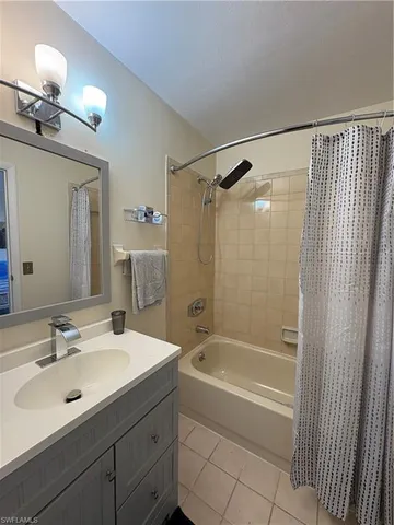 a bathroom with a sink mirror vanity and bathtub
