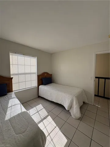 a bedroom with a bed and a lamp