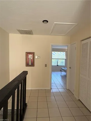 a view of staircase with white walls and railing