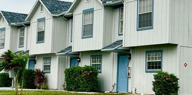 a front view of a house with plants