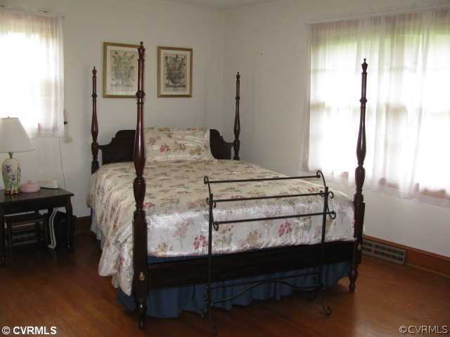 2034 Tuggle Road Farmville, VA 23901 - Photo 10 of 12 a bed sitting in a bedroom next to a window