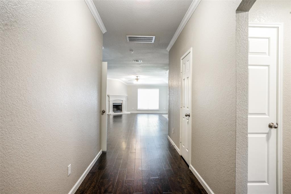1257 Barrel Run Fort Worth, TX 76052 - Photo 4 of 26 flooring, light neutral walls, white crown molding, and white interior doors
