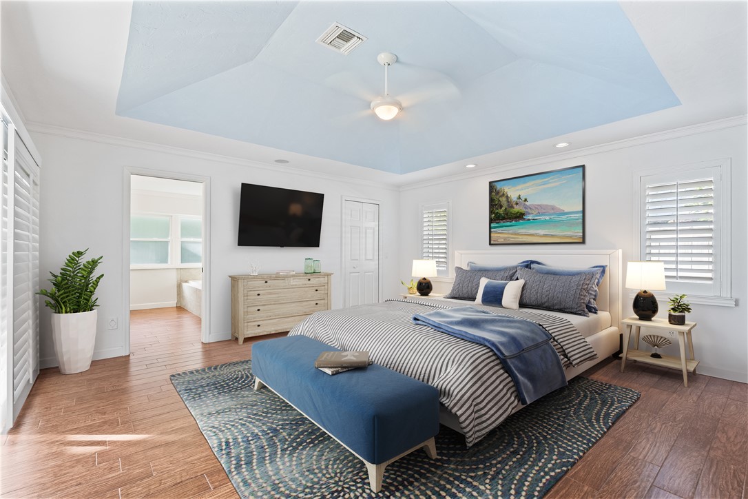1939 Ocean Ridge Circle Vero Beach, FL 32963 - Photo 13 of 33 a bedroom with a large bed a flat screen tv and a couch