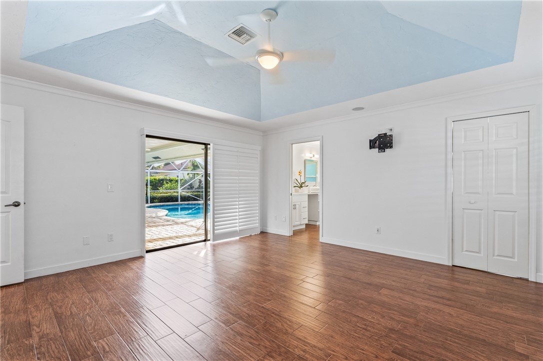 1939 Ocean Ridge Circle Vero Beach, FL 32963 - Photo 14 of 33 an empty room with wooden floor and windows