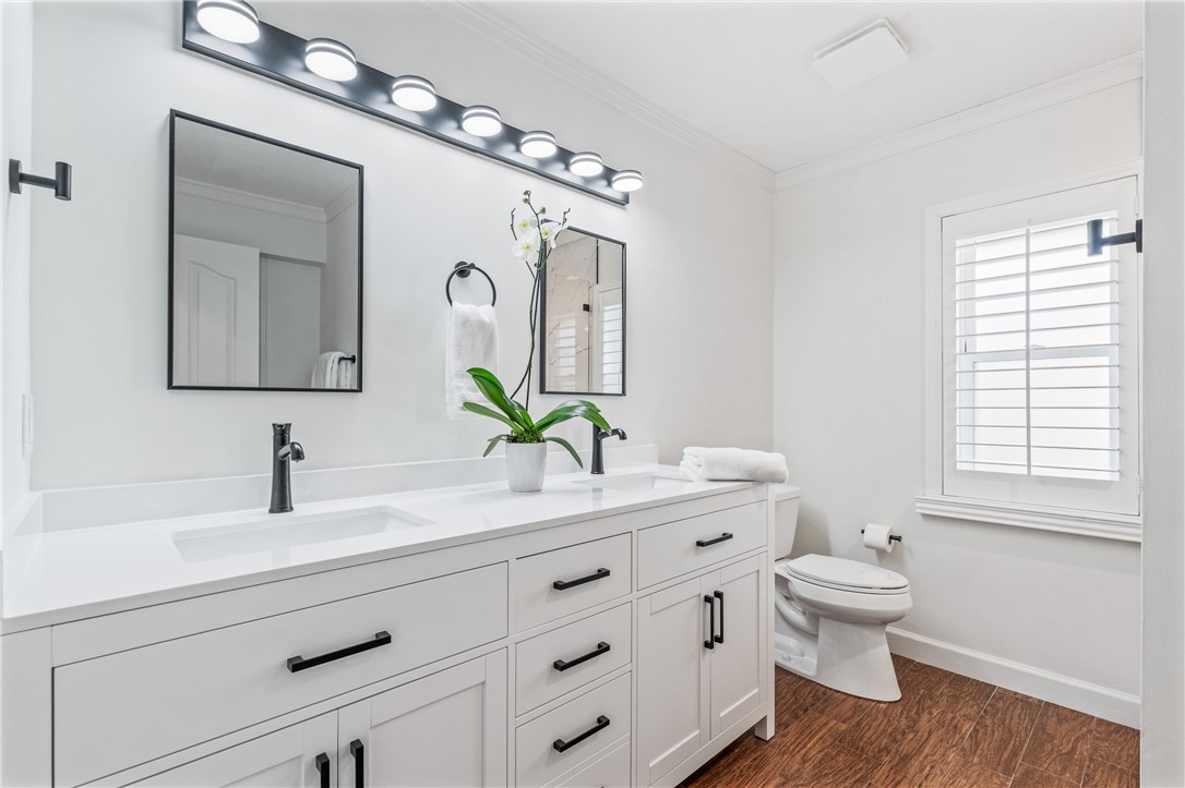 1939 Ocean Ridge Circle Vero Beach, FL 32963 - Photo 17 of 33 a bathroom with a toilet a sink a large mirror and vanity