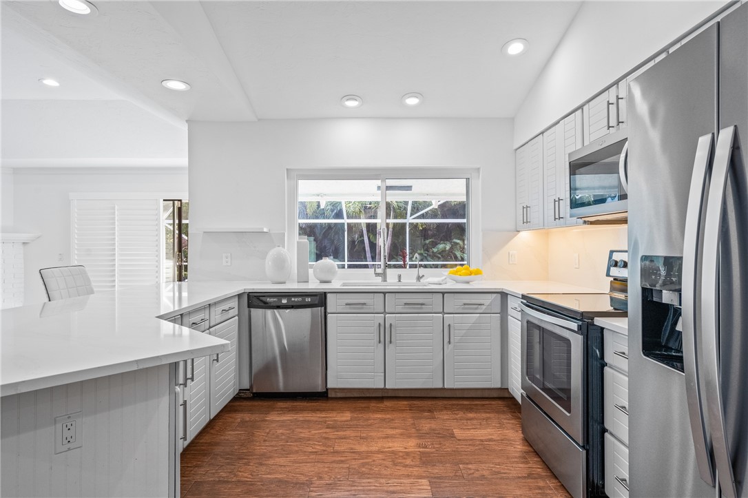 1939 Ocean Ridge Circle Vero Beach, FL 32963 - Photo 20 of 33 a kitchen with stainless steel appliances granite countertop a refrigerator and a stove