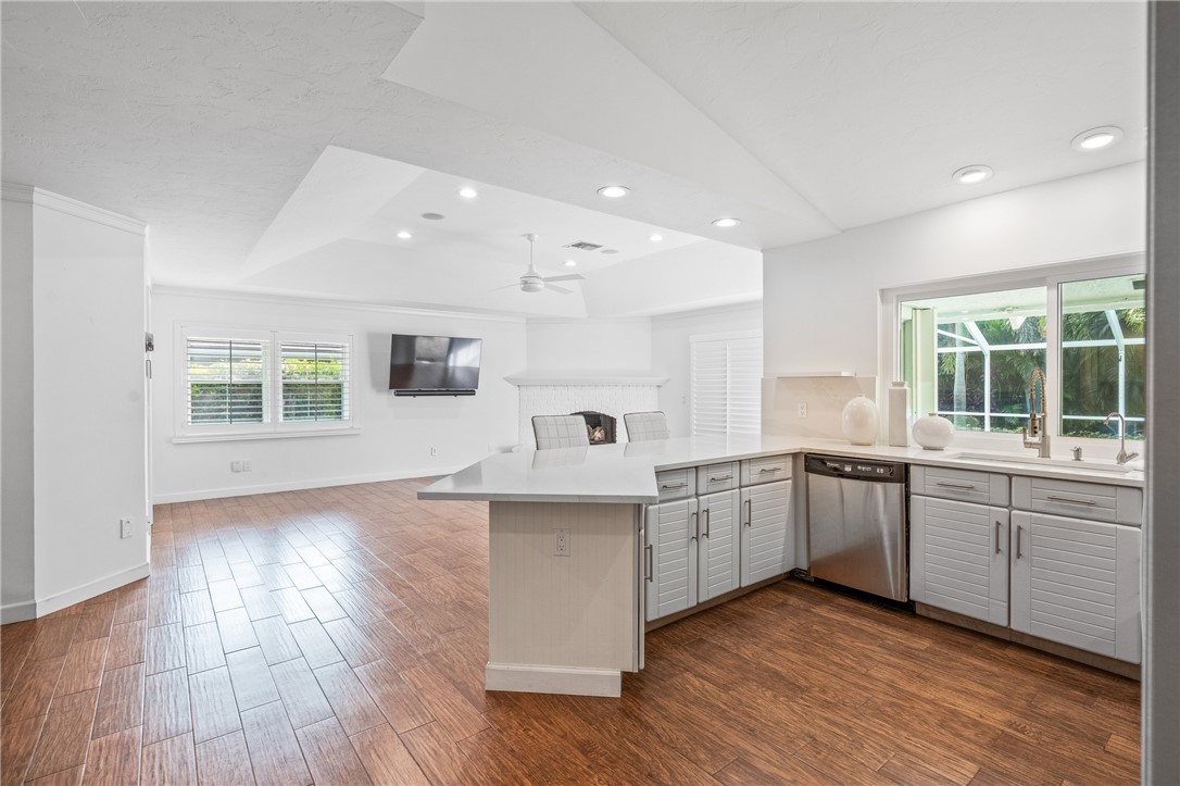 1939 Ocean Ridge Circle Vero Beach, FL 32963 - Photo 24 of 33 a large kitchen with a center island and wooden floor