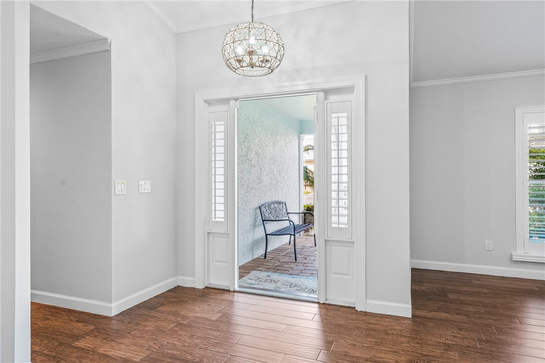 1939 Ocean Ridge Circle Vero Beach, FL 32963 - Photo 3 of 33 a view of a room with wooden floor mirror and windows