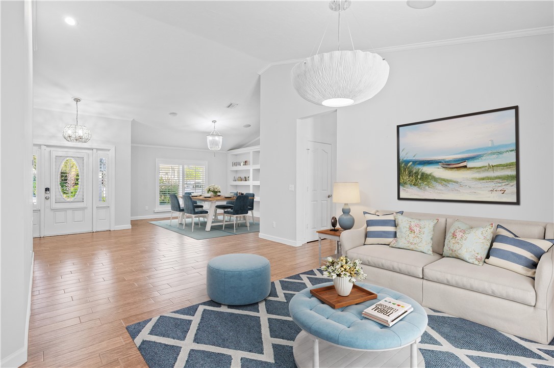 1939 Ocean Ridge Circle Vero Beach, FL 32963 - Photo 7 of 33 a living room with furniture a dining table and a chandelier