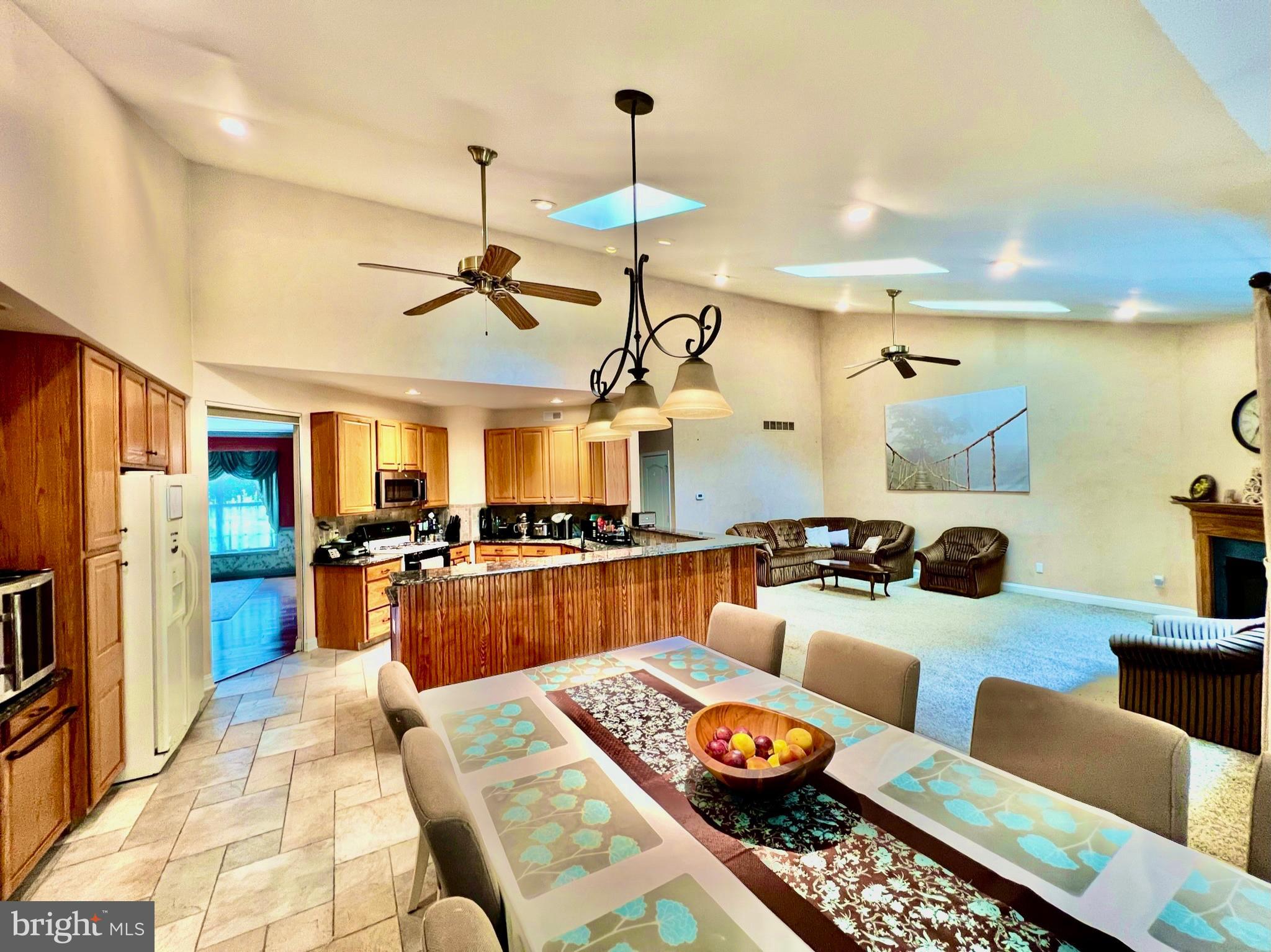 18 Skyline Circle Sewell, NJ 08080 - Photo 19 of 59 a kitchen with a table chairs and refrigerator